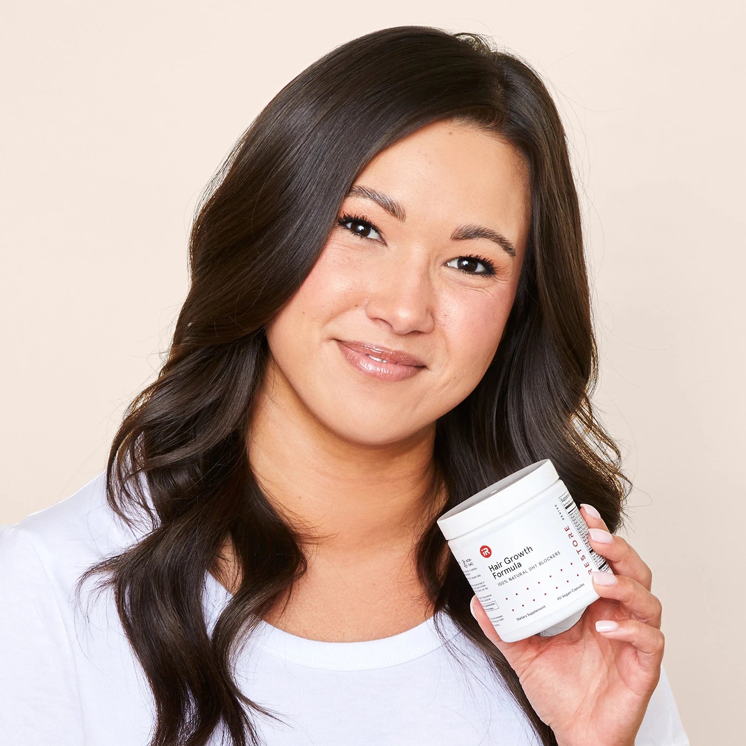 Image of a woman holding the hair of the Hair Growth Formula.