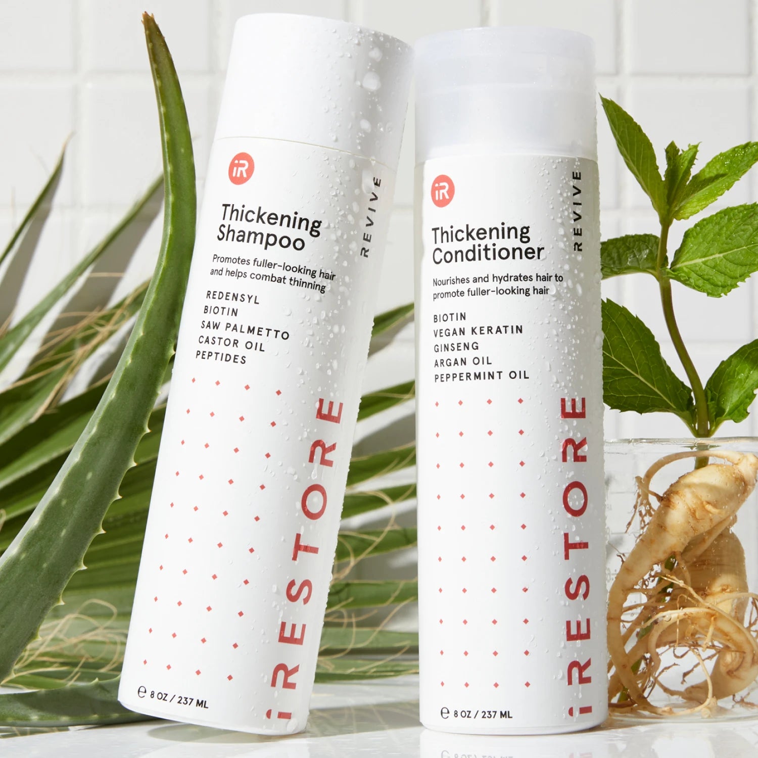 Thickening shampoo and conditioner beside each other with plants in the background