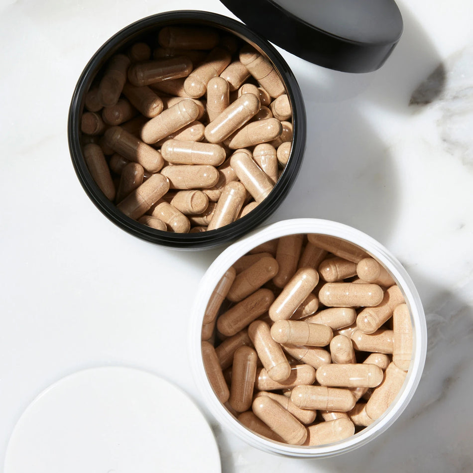 Top down view image of an opened jar of the Advanced Hair Growth Formula and Hair Growth Formula.