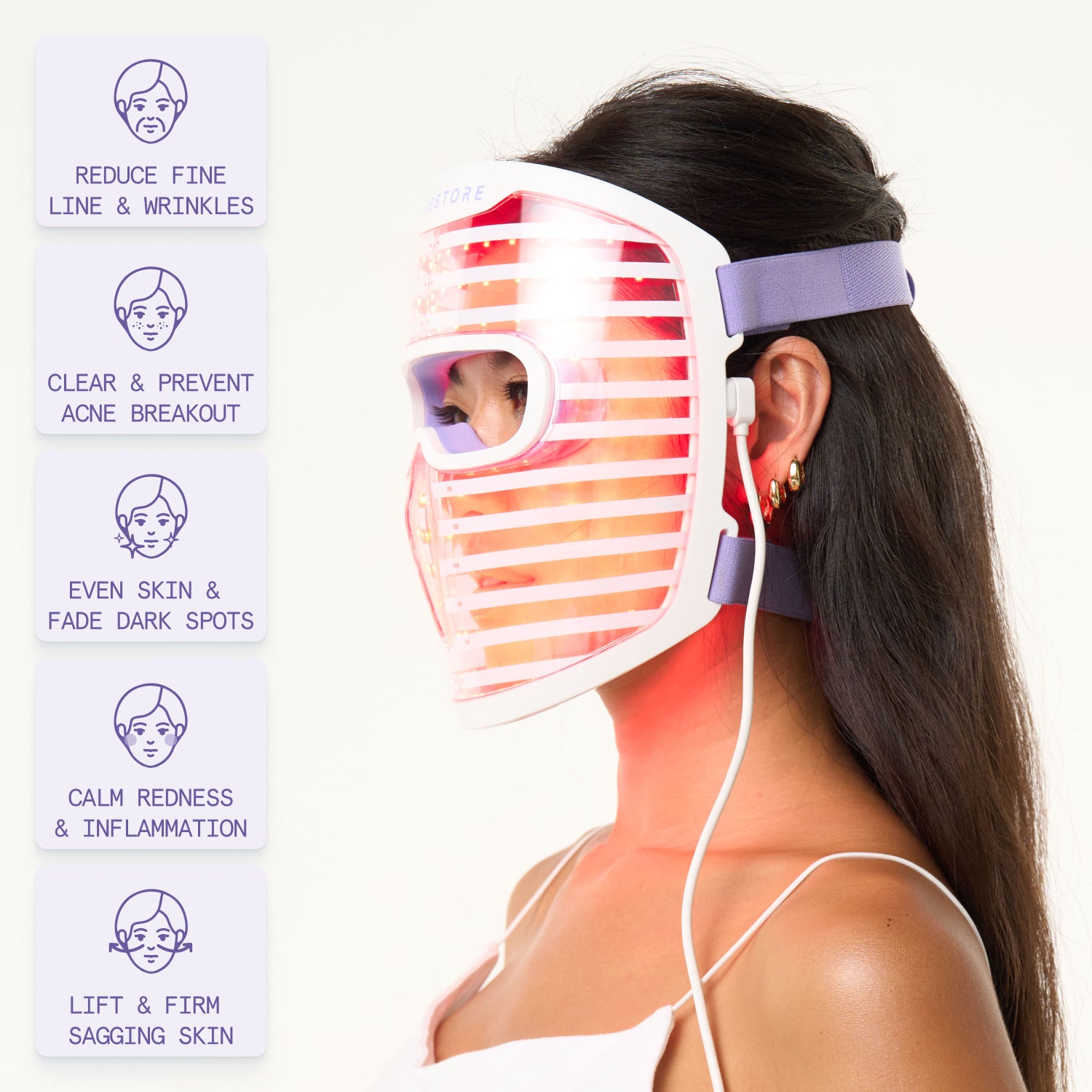 Woman wearing the iRESTORE LED face mask emphasizing the mask's multifunctional skincare advantages:

Reduce Fine Lines & Wrinkles
Clear & Prevent Acne Breakouts
Even Skin Tone & Fade Dark Spots
Calm Redness & Inflammation
Lift & Firm Sagging Skin